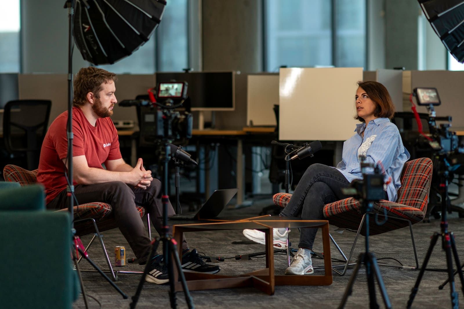 A Chain of Thought episode being recorded on location — multi-camera rig, lighting, and microphones around the host and guest